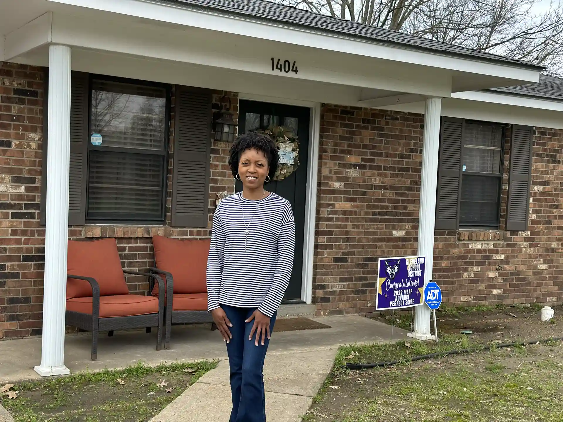 Homeowner standing in front of house