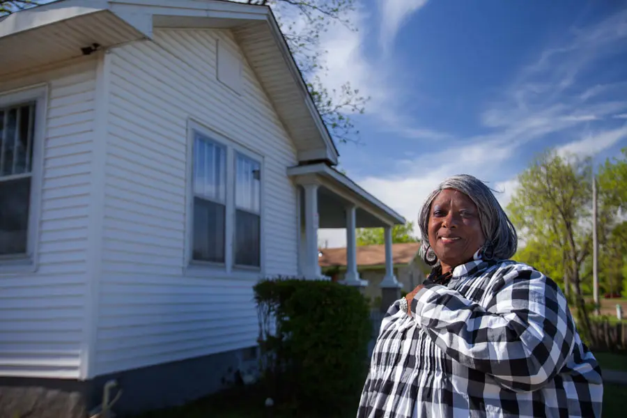 Homeowner in front of her house