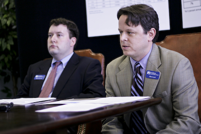 Two men presenting in a board room