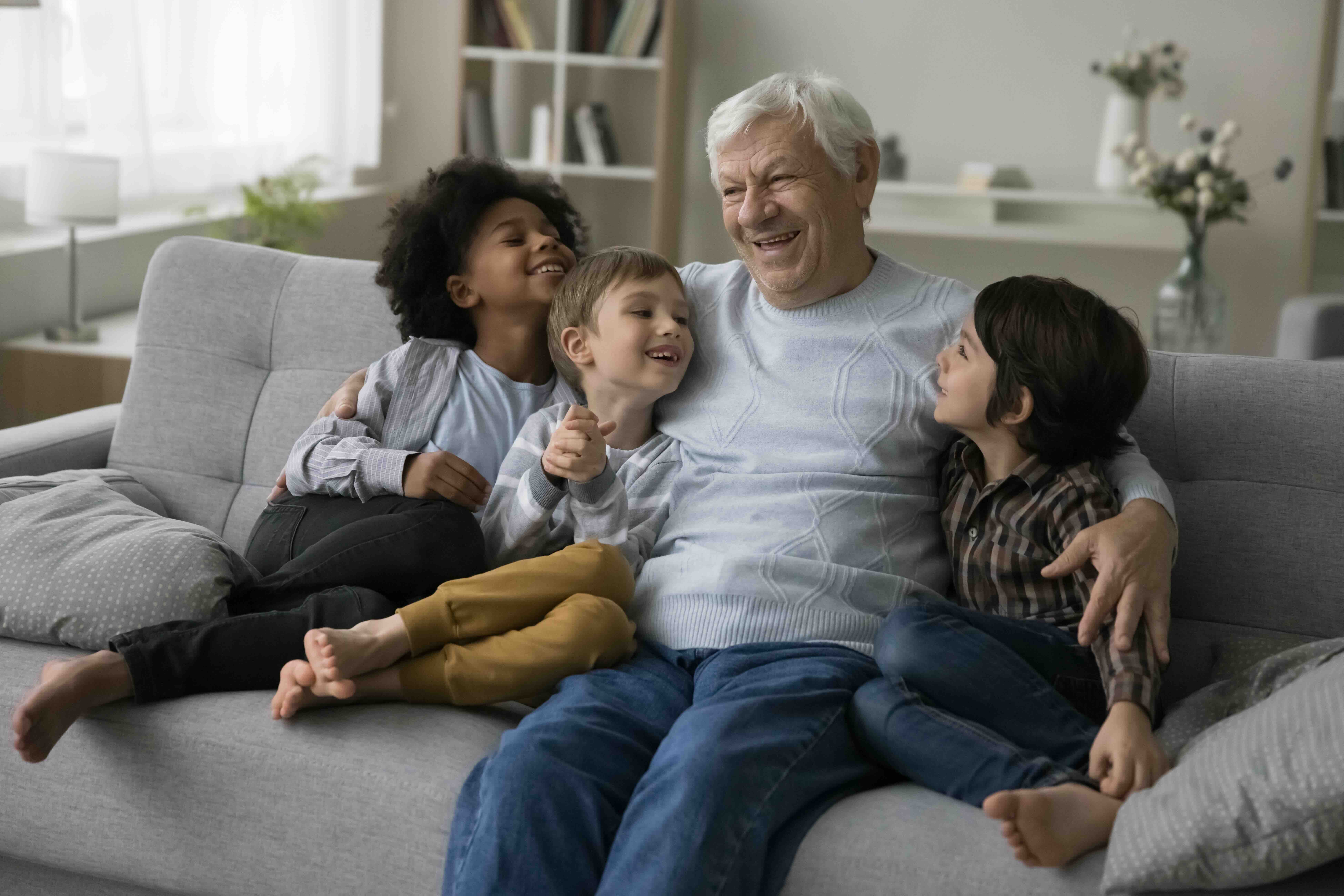 stock-photo-cheerful-old-retired-granddad-hugging-cuddling-cute-little-multiethnic-grandsons-enjoying-family-2283549419